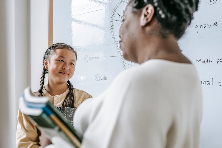 A teacher and a student interact in a classroom setting, fostering learning and engagement
